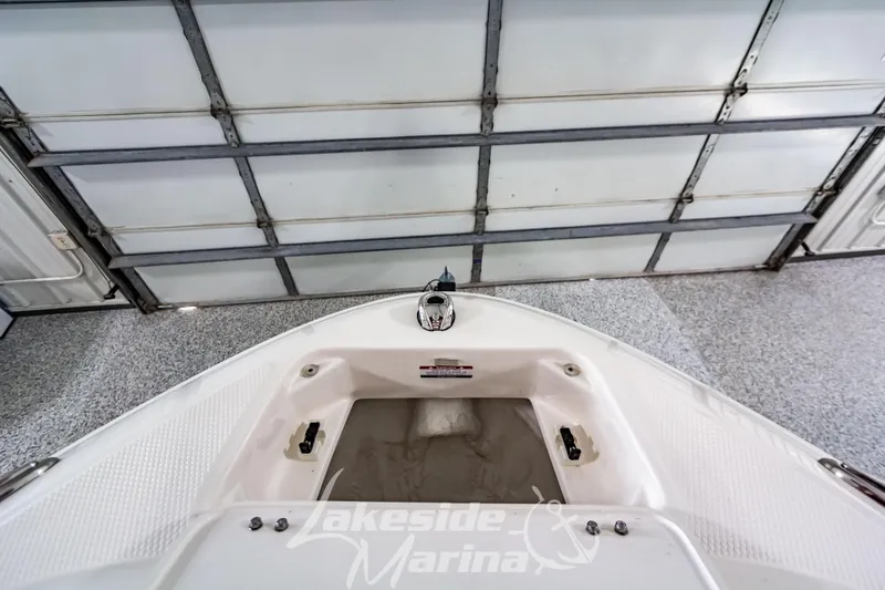 Slide: The Image of 2026 Chaparral 21 SSi boat interior with cushioned seating and blue LED speakers. - 28