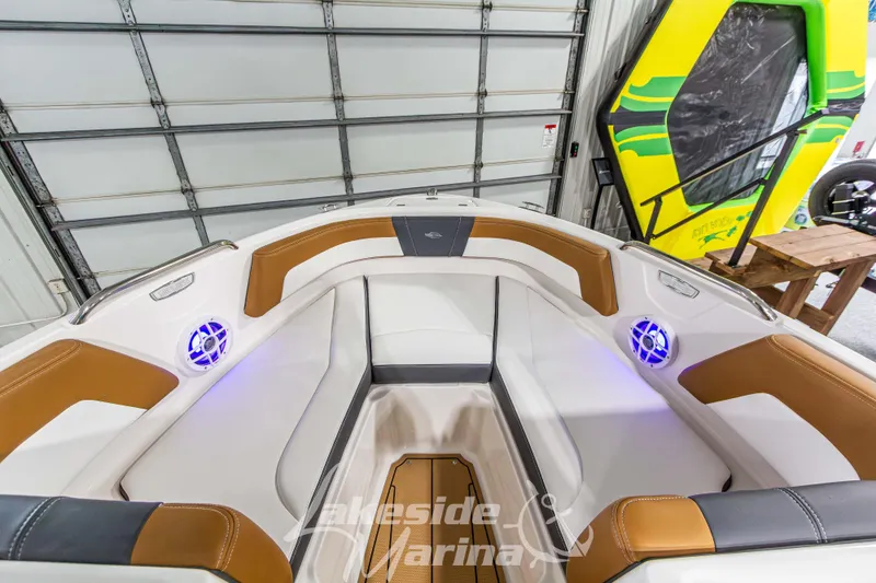 Slide: The Image of 2026 Chaparral 21 SSi boat interior with tan and white seating, blue LED lights. - 29