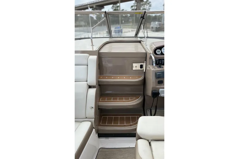 Slide: The Image of 2018 Regal 28 Express boat interior with beige and white seating. - 12