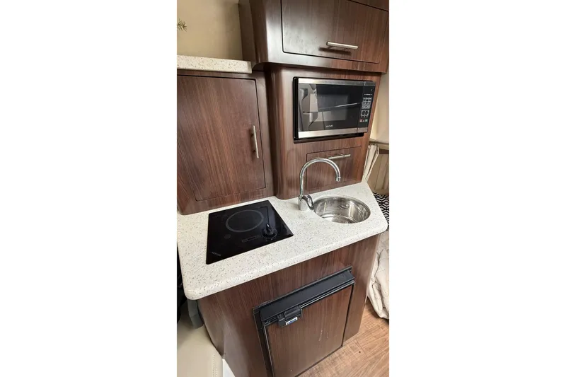 Slide: The Image of 2018 Regal 28 Express cabin interior with beige seating and wood flooring. - 16