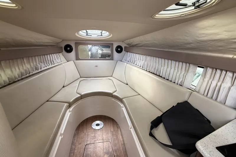 Slide: The Image of 2018 Regal 28 Express boat interior with beige seating and speaker system. - 17