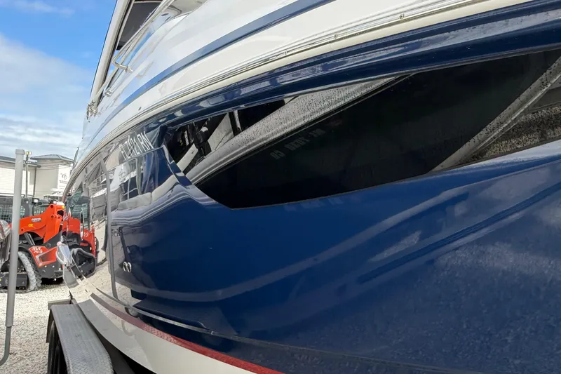 Slide: The Image of 2018 Regal 28 Express boat with sleek design, docked under cloudy sky. - 6