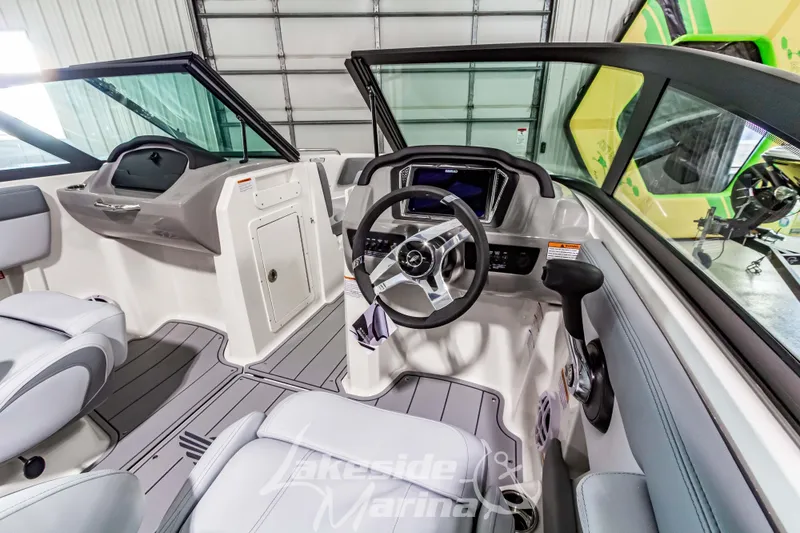 Slide: The Image of Interior view of 2026 Chaparral 21 SSi boat with modern dashboard and steering wheel. - 18