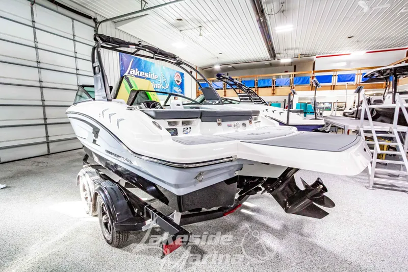 Slide: The Image of 2026 Chaparral 21 SSi boat in showroom, rear view with trailer, Lakeside Marina. - 2