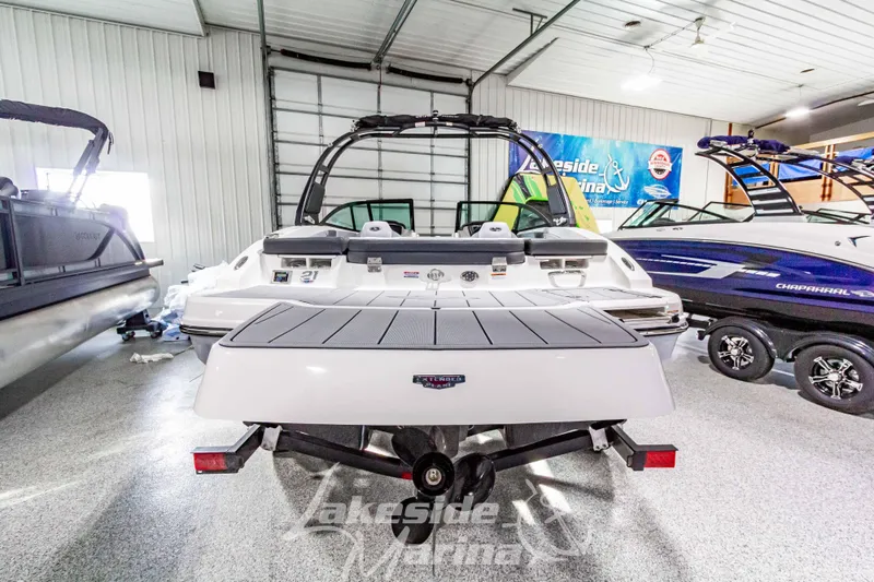 Slide: The Image of Rear view of a 2026 Chaparral 21 SSi boat in a marina. - 3