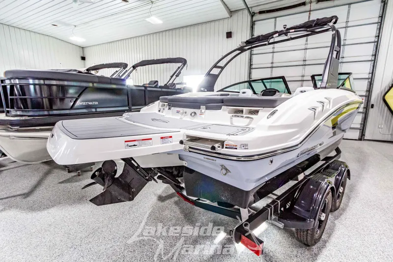 Slide: The Image of 2026 Chaparral 21 SSi boat in showroom, rear view with trailer. - 4