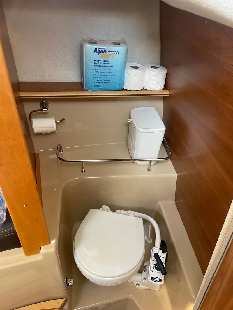 Slide: The Image of 2017 Cutwater C-24 boat bathroom with toilet and supplies. - 12