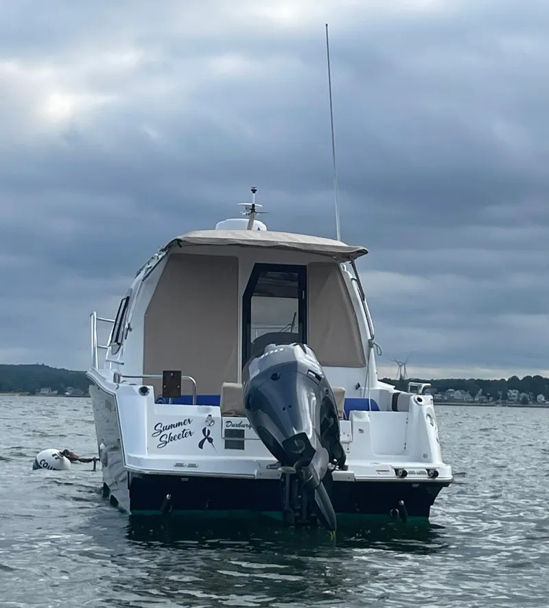 Slide: The Image of 2017 Cutwater C-24 boat on calm water under cloudy sky. - 3