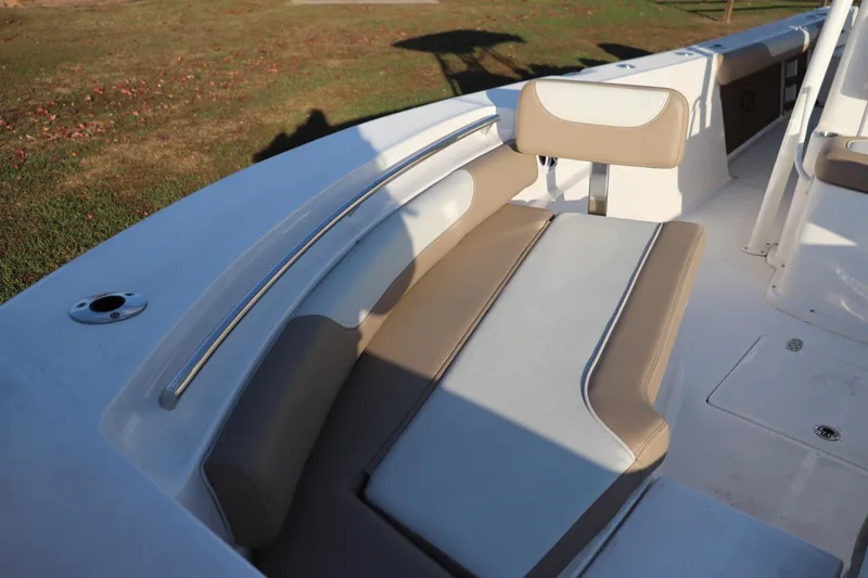 Slide: The Image of 2024 Sea Born LX24 Center Console boat seating area with beige and white cushions. - 2