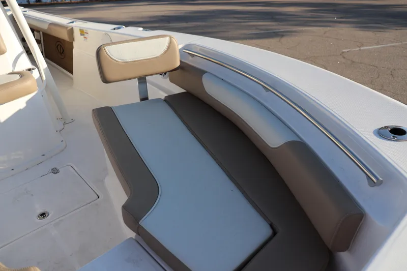 Slide: The Image of 2024 Sea Born LX24 Center Console boat interior with cushioned seating and storage. - 3