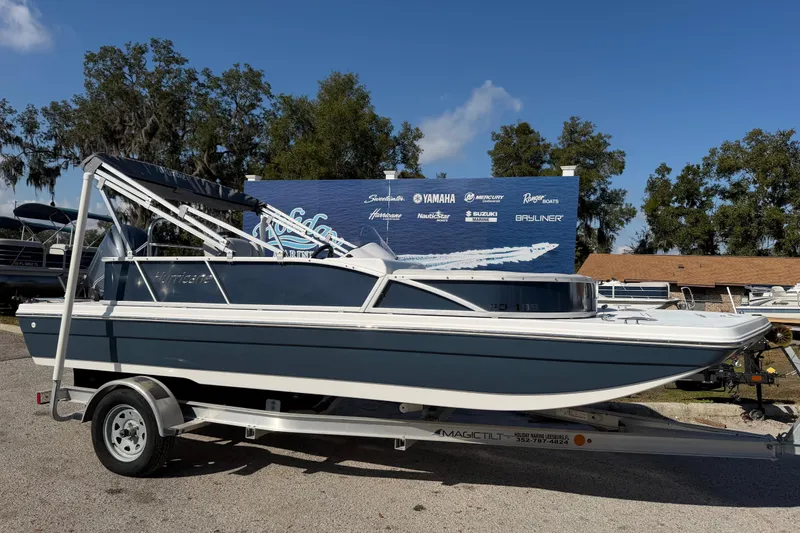 The Image of 2026 Hurricane FunDeck 198 RE OB boat on trailer, outdoor display setting. - 0