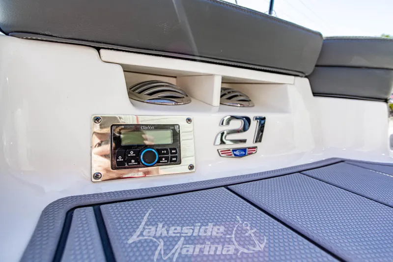 Slide: The Image of 2026 Chaparral 21 SSi OB boat interior with audio system and branding details. - 11