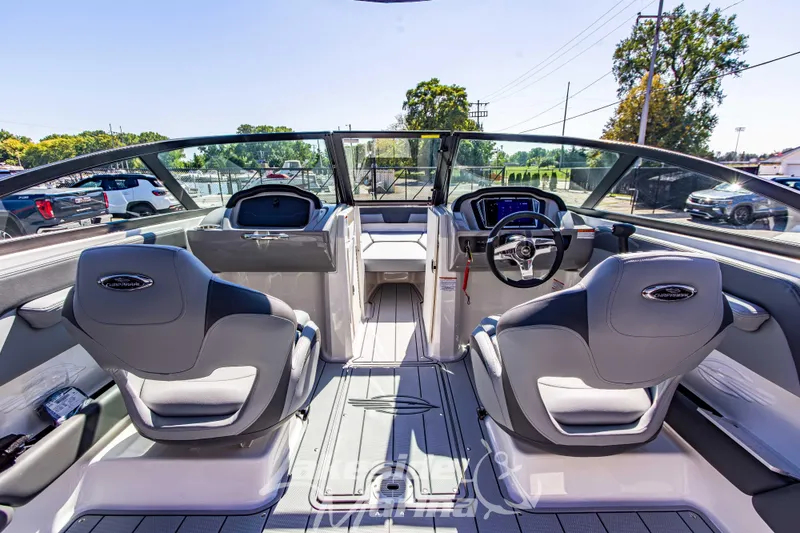 Slide: The Image of Interior view of 2026 Chaparral 21 SSi OB boat, featuring modern seating and dashboard. - 22