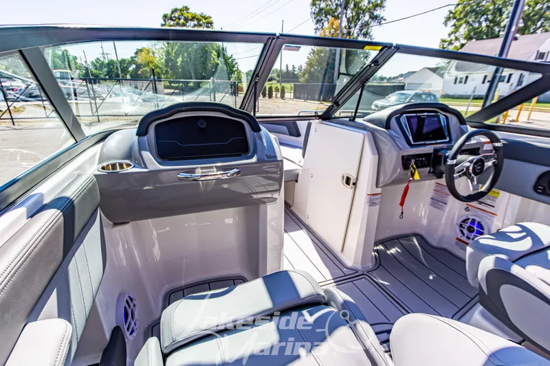 Slide: The Image of Interior view of 2026 Chaparral 21 SSi OB boat, featuring modern dashboard and seating. - 25