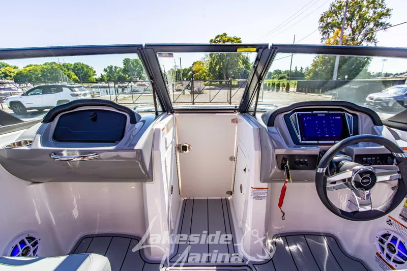 Slide: The Image of Interior view of 2026 Chaparral 21 SSi OB boat with modern dashboard and steering wheel. - 27