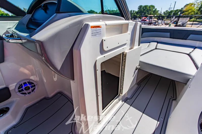 Slide: The Image of 2026 Chaparral 21 SSi OB boat interior with open storage compartment and seating area. - 29