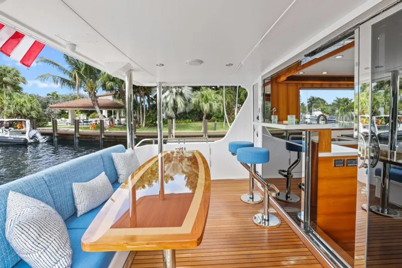 Slide: The Image of Luxurious 2023 Outer Reef Yachts 670 Azure cockpit with elegant seating and bar area. - 11