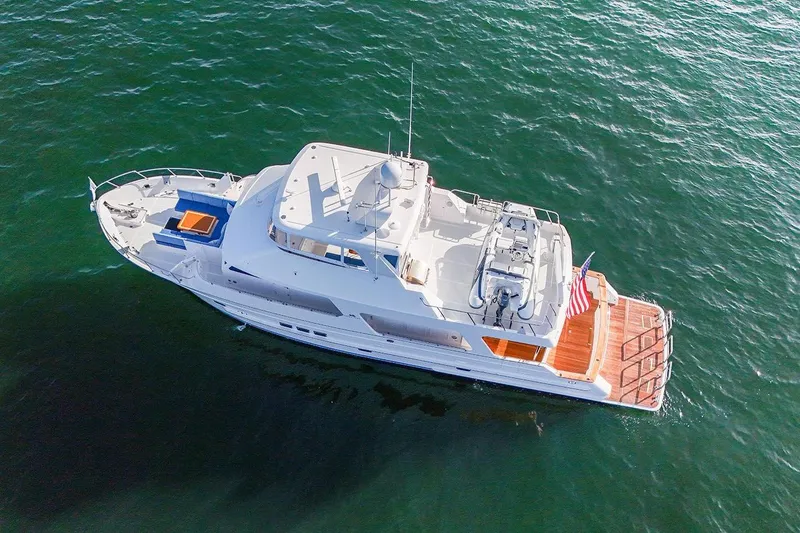 Slide: The Image of 2023 Outer Reef Yachts 670 Azure Custom Cockpit Motoryacht on open water, aerial view. - 2