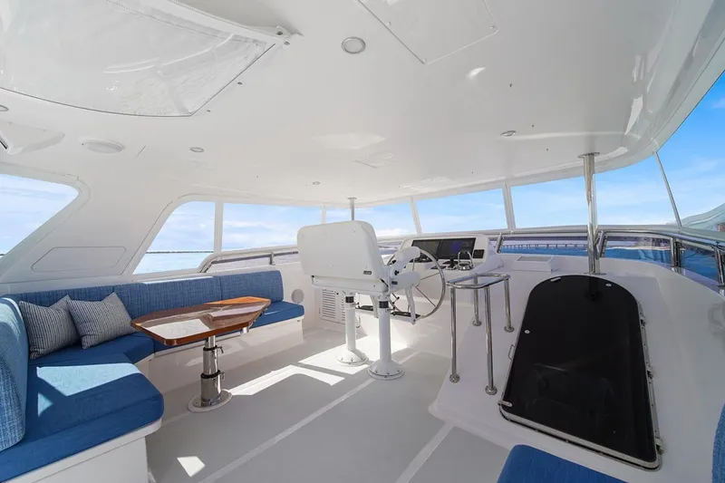 Slide: The Image of Luxurious cockpit of 2023 Outer Reef Yachts 670 Azure Motoryacht with blue seating and helm. - 23