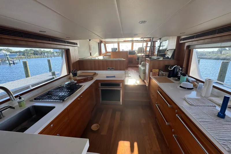 Slide: The Image of Luxurious kitchen interior of 2023 Outer Reef Yachts 670 Azure Motoryacht with scenic water views. - 12