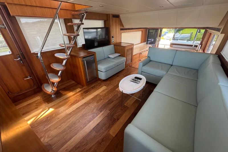 Slide: The Image of Luxurious interior of 2023 Outer Reef Yachts 670 Azure Motoryacht with modern seating and wooden flooring. - 14