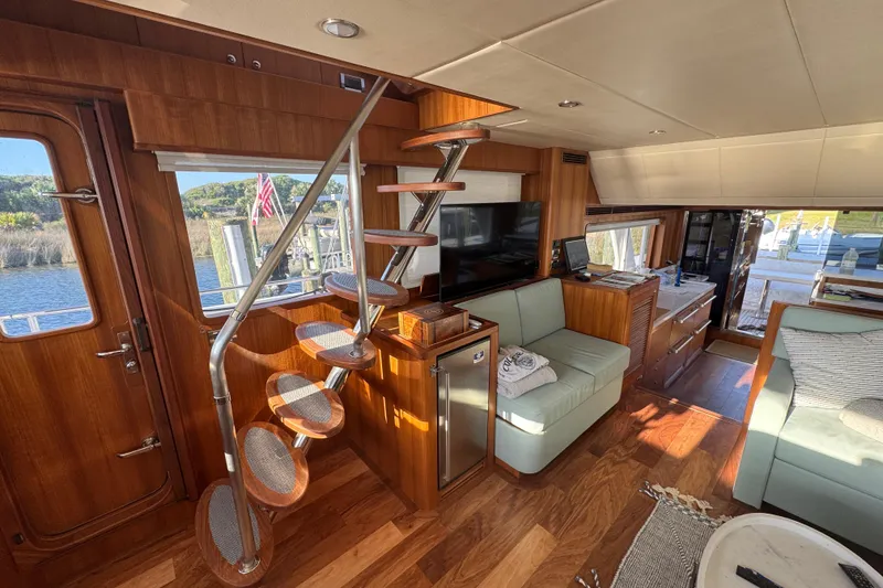 Slide: The Image of Luxurious interior of 2023 Outer Reef Yachts 670 Azure Custom Cockpit Motoryacht, featuring elegant wood finishes. - 16