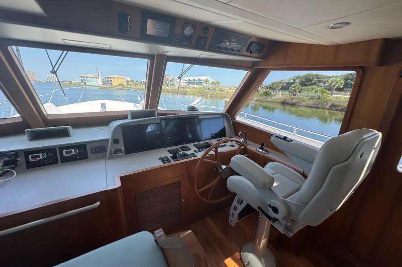 Slide: The Image of Interior helm of 2023 Outer Reef Yachts 670 Azure Custom Cockpit Motoryacht, featuring modern controls. - 18