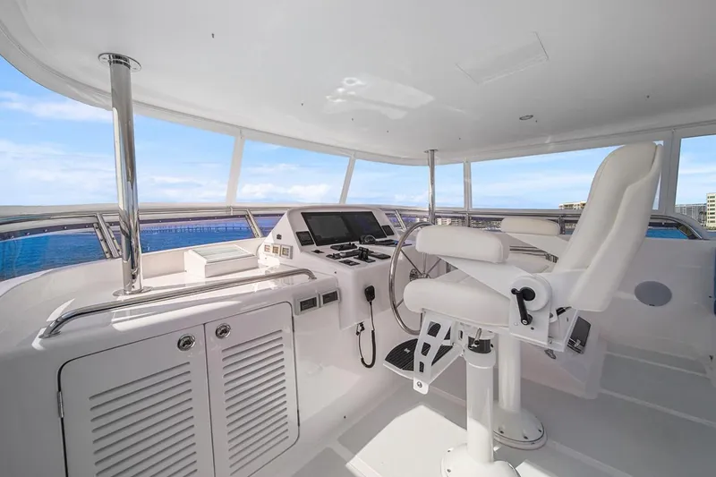 Slide: The Image of Cockpit of 2023 Outer Reef Yachts 670 Azure Custom Motoryacht with modern controls and seating. - 24