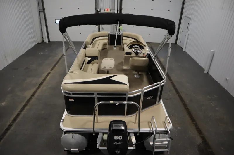 Slide: The Image of 2013 Harris Cruiser 220 pontoon boat in indoor storage, rear view. - 10