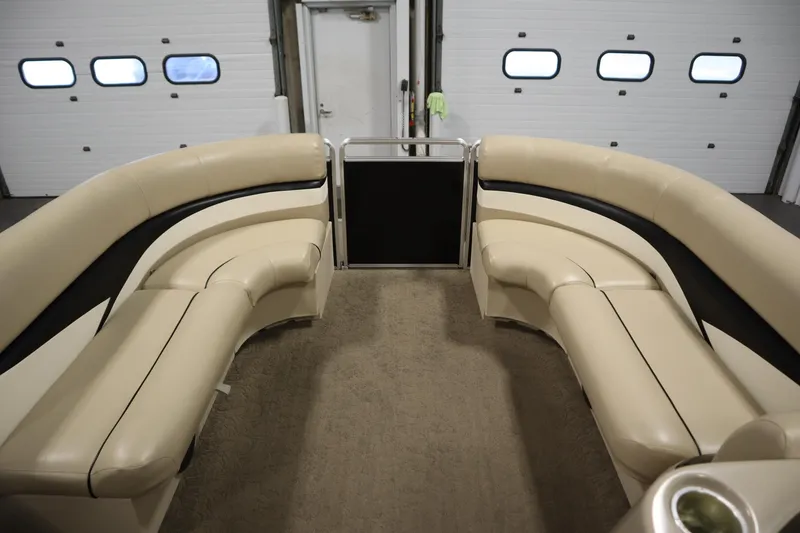 Slide: The Image of 2013 Harris Cruiser 220 interior with beige seating in a garage setting. - 11
