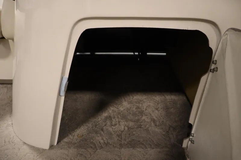 Slide: The Image of 2013 Harris Cruiser 220 storage compartment with open hatch, showcasing interior space. - 18