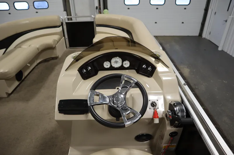 Slide: The Image of 2013 Harris Cruiser 220 boat interior with steering wheel and dashboard controls. - 19