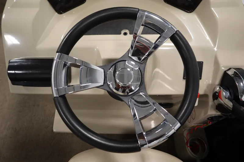 Slide: The Image of Steering wheel of a 2013 Harris Cruiser 220 boat, featuring chrome and black design. - 20