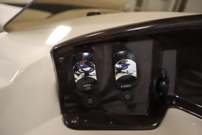 Slide: The Image of Control panel of a 2013 Harris Cruiser 220 with dock lights and stereo switches. - 22
