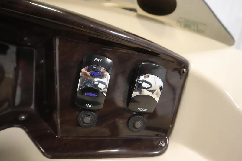 Slide: The Image of Dashboard switches on a 2013 Harris Cruiser 220 boat, featuring navigation and horn controls. - 23