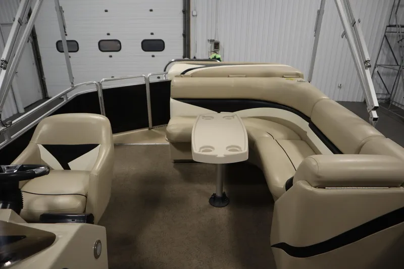Slide: The Image of 2013 Harris Cruiser 220 pontoon boat interior with beige seating and table. - 28