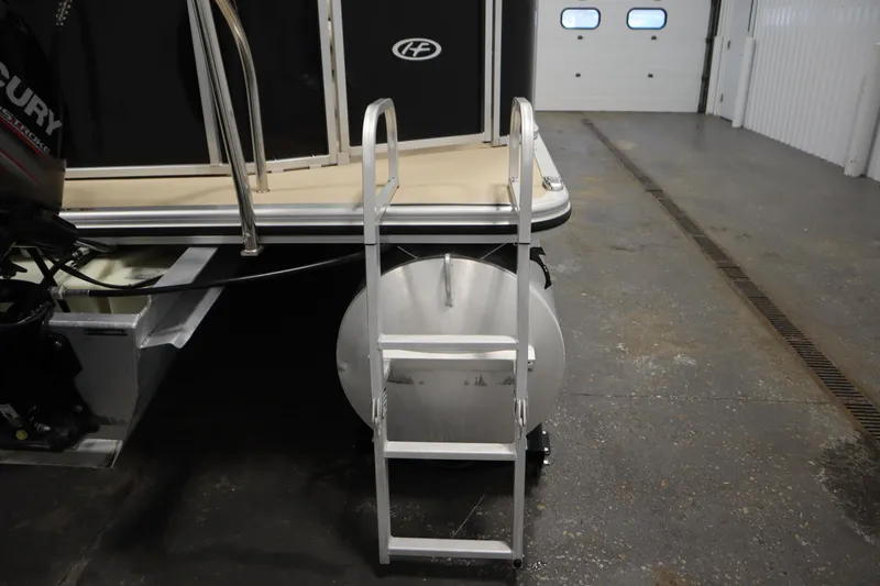 Slide: The Image of 2013 Harris Cruiser 220 boat with ladder and Mercury engine in a garage. - 35