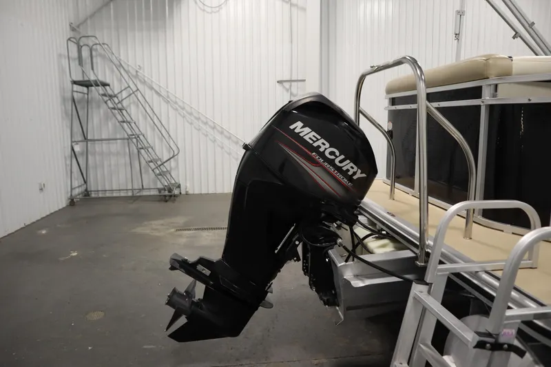 Slide: The Image of 2013 Harris Cruiser 220 with Mercury outboard motor in a storage facility. - 37
