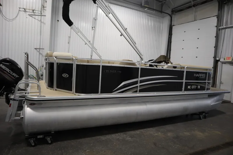 Slide: The Image of 2013 Harris Cruiser 220 pontoon boat in indoor storage facility. - 4