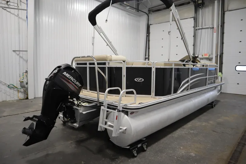 Slide: The Image of 2013 Harris Cruiser 220 pontoon boat with Mercury outboard motor in a garage. - 5