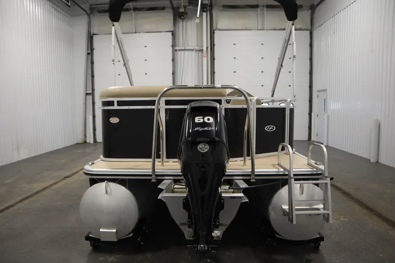 Slide: The Image of 2013 Harris Cruiser 220 pontoon boat with 60 HP engine in indoor storage. - 6