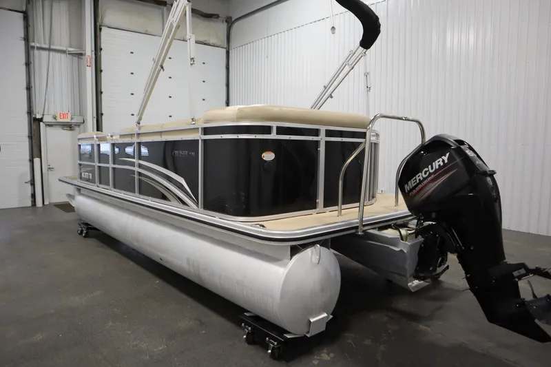Slide: The Image of 2013 Harris Cruiser 220 pontoon boat with Mercury outboard motor in indoor storage. - 7
