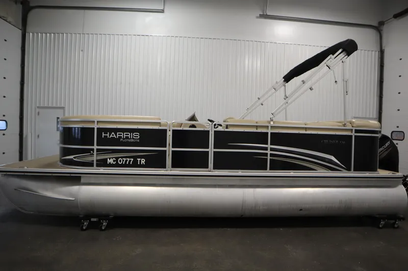 Slide: The Image of 2013 Harris Cruiser 220 pontoon boat in indoor storage, side view. - 8