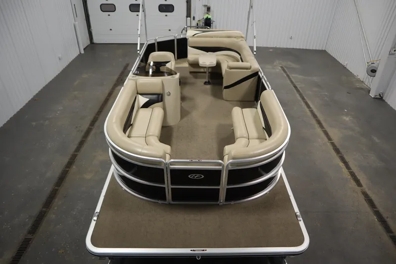 Slide: The Image of 2013 Harris Cruiser 220 pontoon boat with beige seating in a garage setting. - 9