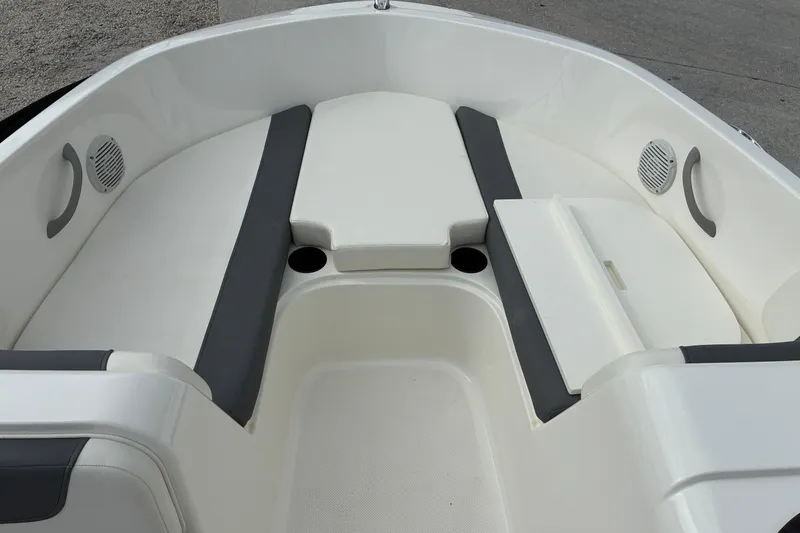 Slide: The Image of 2023 Bayliner Element 180 XL boat interior with cushioned seating and cup holders. - 10