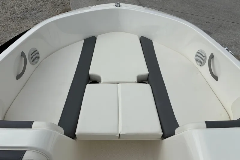 Slide: The Image of 2023 Bayliner Element 180 XL boat interior with cushioned seating and speakers. - 11