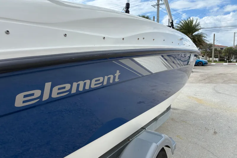 Slide: The Image of 2023 Bayliner Element 180 XL boat, blue and white design, parked outdoors. - 15