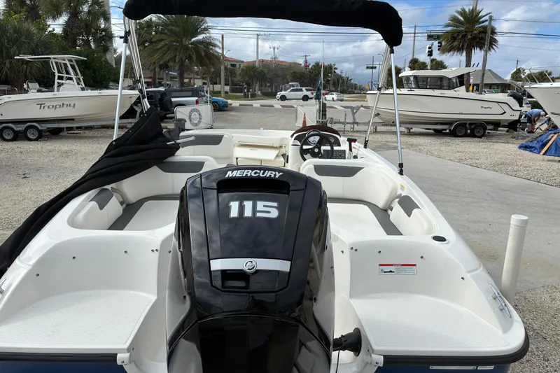 Slide: The Image of 2023 Bayliner Element 180 XL boat with Mercury 115 engine, parked at a marina. - 3