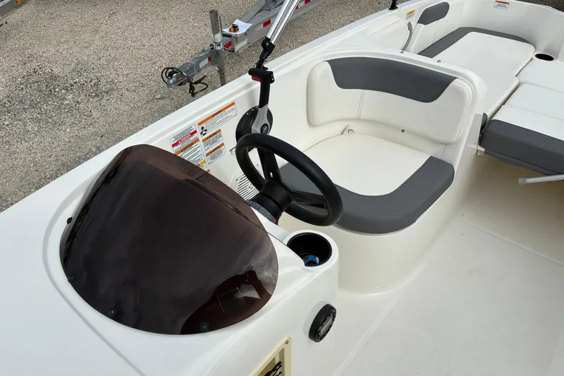 Slide: The Image of 2023 Bayliner Element 180 XL boat interior with steering wheel and seating. - 5