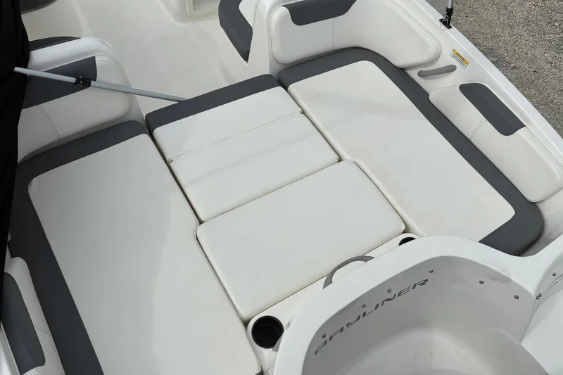 Slide: The Image of 2023 Bayliner Element 180 XL boat interior seating, featuring white and gray cushioned design. - 7